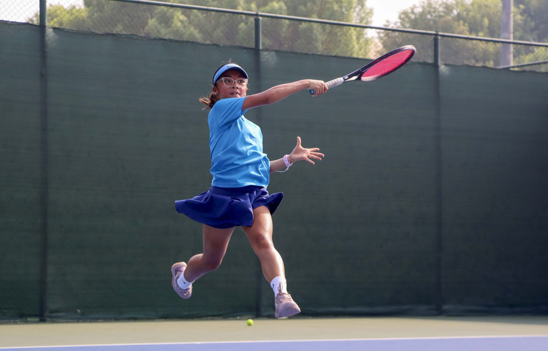 A CF Tennis Academy student mid-forehand.